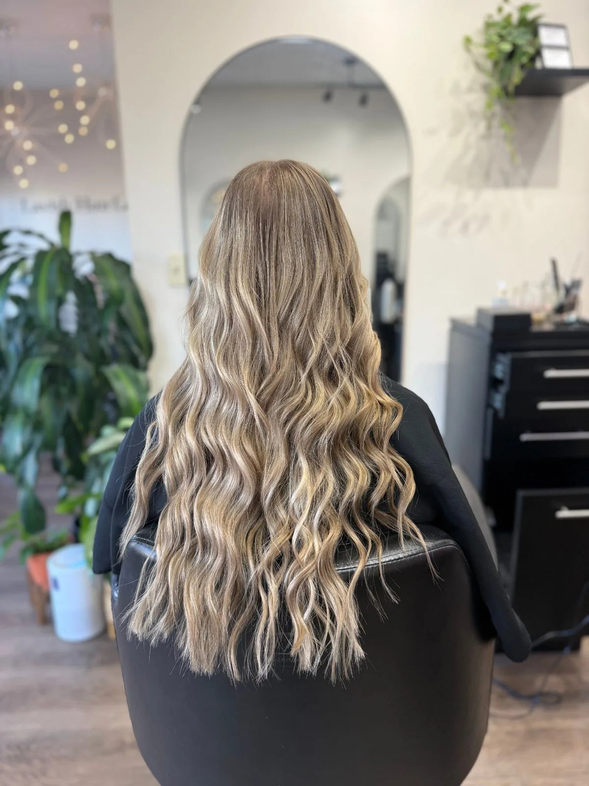 Long, blended blonde hair in soft waves, after a color appointment at Lavish Hair Lounge in Westport, MA
